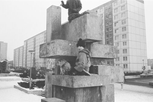 Children play with dogs on a sculpture in front of prefabricated blocks, 1984, Berlin, GDR, Germany, Europe